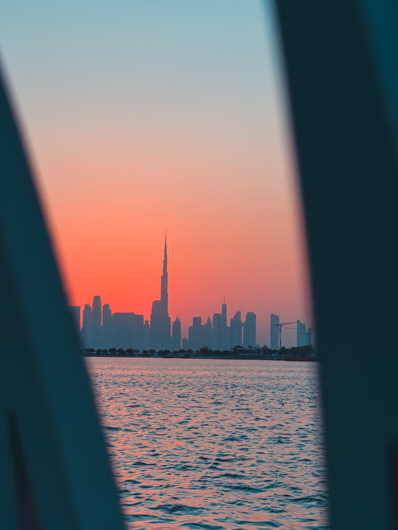 Dubai skyline framed through a window at sunset