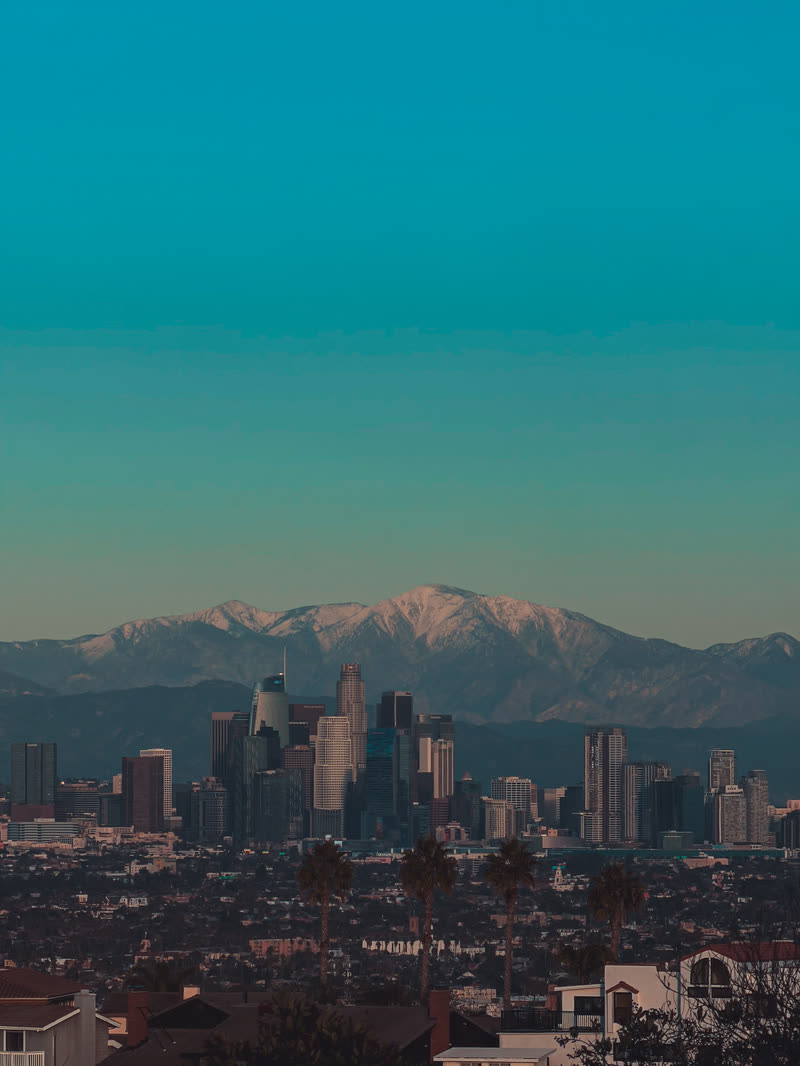 Los Angeles skyline beneath snowy mountains