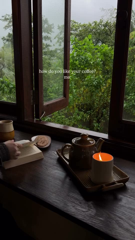 Candle and book by a cabin window